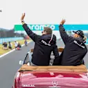 BUDAPEST, HUNGARY - JULY 31: George Russell and Lewis Hamilton of Mercedes and Great Britain during the drivers parade lap at the F1 Grand Prix of Hungary at Hungaroring on July 31, 2022 in Budapest, Hungary. (Photo by Peter Fox/Getty Images)