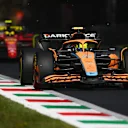 MONZA, ITALY - SEPTEMBER 11: Lando Norris of Great Britain driving the (4) McLaren MCL36 Mercedes leads Carlos Sainz of Spain driving (55) the Ferrari F1-75 during the F1 Grand Prix of Italy at Autodromo Nazionale Monza on September 11, 2022 in Monza, Italy. (Photo by Dan Mullan/Getty Images)