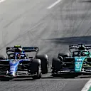 MONZA, ITALY - SEPTEMBER 11: Lance Stroll of Canada driving the (18) Aston Martin AMR22 Mercedes locks a wheel under braking as he battles for track position with Nicholas Latifi of Canada driving the (6) Williams FW44 Mercedes  during the F1 Grand Prix of Italy at Autodromo Nazionale Monza on September 11, 2022 in Monza, Italy. (Photo by Joe Portlock - Formula 1/Formula 1 via Getty Images)