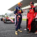 SUZUKA, JAPAN - OCTOBER 08: Pole position qualifier Max Verstappen of the Netherlands and Oracle Red Bull Racing and Third placed qualifier Carlos Sainz of Spain and Ferrari talk in parc ferme during qualifying ahead of the F1 Grand Prix of Japan at Suzuka International Racing Course on October 08, 2022 in Suzuka, Japan. (Photo by Dan Istitene - Formula 1/Formula 1 via Getty Images)