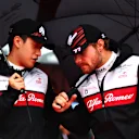 SUZUKA, JAPAN - OCTOBER 09: Zhou Guanyu of China and Alfa Romeo F1 and Valtteri Bottas of Finland and Alfa Romeo F1 talk on from the grid during the F1 Grand Prix of Japan at Suzuka International Racing Course on October 09, 2022 in Suzuka, Japan. (Photo by Dan Istitene - Formula 1/Formula 1 via Getty Images)