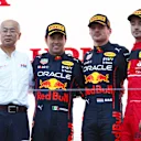 SUZUKA, JAPAN - OCTOBER 09: Race winner and 2022 F1 World Drivers Champion Max Verstappen of Netherlands and Oracle Red Bull Racing (second from right), Second placed Sergio Perez of Mexico and Oracle Red Bull Racing (second from left) and Third placed Charles Leclerc of Monaco and Ferrari celebrate on the podium during the F1 Grand Prix of Japan at Suzuka International Racing Course on October 09, 2022 in Suzuka, Japan. (Photo by Clive Rose/Getty Images)