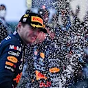 SUZUKA, JAPAN - OCTOBER 09: Race winner and 2022 F1 World Drivers Champion Max Verstappen of the Netherlands and Oracle Red Bull Racing celebrates on the podium during the F1 Grand Prix of Japan at Suzuka International Racing Course on October 09, 2022 in Suzuka, Japan. (Photo by Clive Mason/Getty Images)