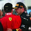 SUZUKA, JAPAN - OCTOBER 09: Race winner and 2022 F1 World Drivers Champion Max Verstappen of Netherlands and Oracle Red Bull Racing and Third placed Charles Leclerc of Monaco and Ferrari celebrate on the podium during the F1 Grand Prix of Japan at Suzuka International Racing Course on October 09, 2022 in Suzuka, Japan. (Photo by Clive Mason/Getty Images)