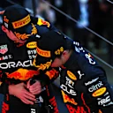 SUZUKA, JAPAN - OCTOBER 09: Race winner and 2022 F1 World Drivers Champion Max Verstappen of Netherlands and Oracle Red Bull Racing and Second placed Sergio Perez of Mexico and Oracle Red Bull Racing celebrate on the podium during the F1 Grand Prix of Japan at Suzuka International Racing Course on October 09, 2022 in Suzuka, Japan. (Photo by Mark Thompson/Getty Images )