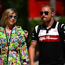 MIAMI, FLORIDA - MAY 06: Valtteri Bottas of Finland and Alfa Romeo F1 and his girlfriend cyclist Tiffany Cromwell walk in the Paddock prior to practice ahead of the F1 Grand Prix of Miami at the Miami International Autodrome on May 06, 2022 in Miami, Florida. (Photo by Clive Mason - Formula 1/Formula 1 via Getty Images)