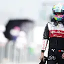 MIAMI, FLORIDA - MAY 07: 17th placed qualifier Zhou Guanyu of China and Alfa Romeo F1 walks in the Pitlane during qualifying ahead of the F1 Grand Prix of Miami at the Miami International Autodrome on May 07, 2022 in Miami, Florida. (Photo by Mark Thompson/Getty Images)