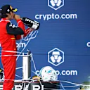 MIAMI, FLORIDA - MAY 08: Third placed Carlos Sainz of Spain and Ferrari celebrates on the podium during the F1 Grand Prix of Miami at the Miami International Autodrome on May 08, 2022 in Miami, Florida. (Photo by Chris Graythen/Getty Images)