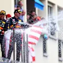MONTE-CARLO, MONACO - MAY 29: Race winner Sergio Perez of Mexico and Oracle Red Bull Racing and Red Bull Racing Team Principal Christian Horner celebrate on the podium as Third placed Max Verstappen of the Netherlands and Oracle Red Bull Racing sprays sparkling wine during the F1 Grand Prix of Monaco at Circuit de Monaco on May 29, 2022 in Monte-Carlo, Monaco. (Photo by Dan Istitene - Formula 1/Formula 1 via Getty Images)