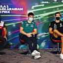 JEDDAH, SAUDI ARABIA - MARCH 25: (L-R) Valtteri Bottas of Finland and Alfa Romeo F1, Lance Stroll of Canada and Aston Martin F1 Team and George Russell of Great Britain and Mercedes attend the Drivers Press Conference before practice ahead of the F1 Grand Prix of Saudi Arabia at the Jeddah Corniche Circuit on March 25, 2022 in Jeddah, Saudi Arabia. (Photo by Clive Mason/Getty Images)
