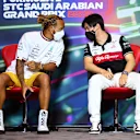 JEDDAH, SAUDI ARABIA - MARCH 25: Lewis Hamilton of Great Britain and Mercedes and Zhou Guanyu of China and Alfa Romeo F1 talk in the Drivers Press Conference before practice ahead of the F1 Grand Prix of Saudi Arabia at the Jeddah Corniche Circuit on March 25, 2022 in Jeddah, Saudi Arabia. (Photo by Clive Mason/Getty Images)