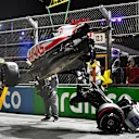 JEDDAH, SAUDI ARABIA - MARCH 26: Track marshals clean debris from the track following the crash of Mick Schumacher of Germany and Haas F1 during qualifying ahead of the F1 Grand Prix of Saudi Arabia at the Jeddah Corniche Circuit on March 26, 2022 in Jeddah, Saudi Arabia. (Photo by Clive Mason/Getty Images)