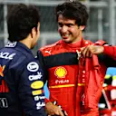 JEDDAH, SAUDI ARABIA - MARCH 26: Third place qualifier Carlos Sainz of Spain and Ferrari talks with Pole position qualifier Sergio Perez of Mexico and Oracle Red Bull Racing in parc ferme during qualifying ahead of the F1 Grand Prix of Saudi Arabia at the Jeddah Corniche Circuit on March 26, 2022 in Jeddah, Saudi Arabia. (Photo by Mark Thompson/Getty Images)