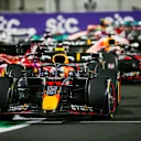JEDDAH, SAUDI ARABIA - MARCH 27: Sergio Perez of Mexico and Red Bull Racing leads into the first corner during the F1 Grand Prix of Saudi Arabia at the Jeddah Corniche Circuit on March 27, 2022 in Jeddah, Saudi Arabia. (Photo by Peter Fox/Getty Images)
