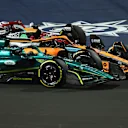 JEDDAH, SAUDI ARABIA - MARCH 27: Lance Stroll of Canada driving the (18) Aston Martin AMR22 Mercedes Daniel Ricciardo of Australia driving the (3) McLaren MCL36 Mercedes and Zhou Guanyu of China driving the (24) Alfa Romeo F1 C42 Ferrari on track during the F1 Grand Prix of Saudi Arabia at the Jeddah Corniche Circuit on March 27, 2022 in Jeddah, Saudi Arabia. (Photo by Lars Baron/Getty Images)