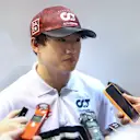 SINGAPORE, SINGAPORE - SEPTEMBER 30: Yuki Tsunoda of Japan and Scuderia AlphaTauri talks to the media in the Paddock after practice ahead of the F1 Grand Prix of Singapore at Marina Bay Street Circuit on September 30, 2022 in Singapore, Singapore. (Photo by Peter Fox/Getty Images,)