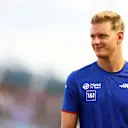 SINGAPORE, SINGAPORE - OCTOBER 02: Mick Schumacher of Germany and Haas F1 looks on from the drivers parade prior to the F1 Grand Prix of Singapore at Marina Bay Street Circuit on October 02, 2022 in Singapore, Singapore. (Photo by Mark Thompson/Getty Images,)