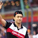 SINGAPORE, SINGAPORE - OCTOBER 02: Zhou Guanyu of China and Alfa Romeo F1 waves to the crowd on the drivers parade prior to  the F1 Grand Prix of Singapore at Marina Bay Street Circuit on October 02, 2022 in Singapore, Singapore. (Photo by Dan Istitene - Formula 1/Formula 1 via Getty Images)