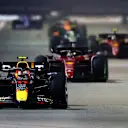 SINGAPORE, SINGAPORE - OCTOBER 02: Sergio Perez of Mexico driving the (11) Oracle Red Bull Racing RB18 leads Charles Leclerc of Monaco driving the (16) Ferrari F1-75 during the F1 Grand Prix of Singapore at Marina Bay Street Circuit on October 02, 2022 in Singapore, Singapore. (Photo by Clive Rose/Getty Images,)