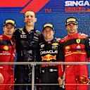 SINGAPORE, SINGAPORE - OCTOBER 02: Race winner Sergio Perez of Mexico and Oracle Red Bull Racing (second from right), Second placed Charles Leclerc of Monaco and Ferrari (L), Third placed Carlos Sainz of Spain and Ferrari (R) and Red Bull Racing race engineer Hugh Bird (second from left) celebrate on the podium during the F1 Grand Prix of Singapore at Marina Bay Street Circuit on October 02, 2022 in Singapore, Singapore. (Photo by Clive Rose/Getty Images,)