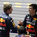 SINGAPORE, SINGAPORE - OCTOBER 02: Race winner Sergio Perez of Mexico and Oracle Red Bull Racing is congratulated by seventh placed Max Verstappen of the Netherlands and Oracle Red Bull Racing in parc ferme during the F1 Grand Prix of Singapore at Marina Bay Street Circuit on October 02, 2022 in Singapore, Singapore. (Photo by Clive Rose/Getty Images,)