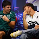 SINGAPORE, SINGAPORE - SEPTEMBER 29: Pierre Gasly of France and Scuderia AlphaTauri and Lance Stroll of Canada and Aston Martin F1 Team talk in the Drivers Press Conference during previews ahead of the F1 Grand Prix of Singapore at Marina Bay Street Circuit on September 29, 2022 in Singapore, Singapore. (Photo by Clive Mason/Getty Images,)