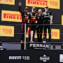 BARCELONA, SPAIN - MAY 22: Race winner Max Verstappen of the Netherlands and Oracle Red Bull Racing, Second placed Sergio Perez of Mexico and Oracle Red Bull Racing and Third placed George Russell of Great Britain and Mercedes celebrate on the podium during the F1 Grand Prix of Spain at Circuit de Barcelona-Catalunya on May 22, 2022 in Barcelona, Spain. (Photo by Alex Pantling - Formula 1/Formula 1 via Getty Images)