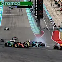 AUSTIN, TEXAS - OCTOBER 23: Max Verstappen of the Netherlands driving the (1) Oracle Red Bull Racing RB18 leads Carlos Sainz of Spain driving (55) the Ferrari F1-75 and the rest of the field at the start during the F1 Grand Prix of USA at Circuit of The Americas on October 23, 2022 in Austin, Texas. (Photo by Mark Thompson/Getty Images)