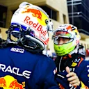 BAHRAIN, BAHRAIN - MARCH 04: Pole position qualifier Max Verstappen of the Netherlands and Oracle Red Bull Racing and Second placed qualifier Sergio Perez of Mexico and Oracle Red Bull Racing talk in parc ferme during qualifying ahead of the F1 Grand Prix of Bahrain at Bahrain International Circuit on March 04, 2023 in Bahrain, Bahrain. (Photo by Mark Thompson/Getty Images)