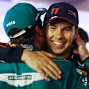 BAHRAIN, BAHRAIN - MARCH 05: Second placed Sergio Perez of Mexico and Oracle Red Bull Racing congratulates Third placed Fernando Alonso of Spain and Aston Martin F1 Team in parc ferme during the F1 Grand Prix of Bahrain at Bahrain International Circuit on March 05, 2023 in Bahrain, Bahrain. (Photo by Bryn Lennon - Formula 1/Formula 1 via Getty Images)