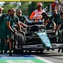 Mechanics run back Aston Martin's Canadian driver Lance Stroll's car in the pit area after a crash during the second practice session, ahead of the Italian Formula One Grand Prix at Autodromo Nazionale Monza circuit, in Monza on September 1, 2023. (Photo by Ben Stansall / AFP) (Photo by BEN STANSALL/AFP via Getty Images)