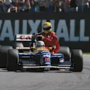An iconic moment captured: Nigel Mansell gives Senna a lift home at the Silverstone circuit after the 1991 British Grand Prix