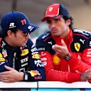 ABU DHABI, UNITED ARAB EMIRATES - NOVEMBER 26: Sergio Perez of Mexico and Oracle Red Bull Racing and Carlos Sainz of Spain and Ferrari talk on the drivers parade prior to the F1 Grand Prix of Abu Dhabi at Yas Marina Circuit on November 26, 2023 in Abu Dhabi, United Arab Emirates. (Photo by Clive Rose/Getty Images)