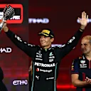 ABU DHABI, UNITED ARAB EMIRATES - NOVEMBER 26: Third placed George Russell of Great Britain and Mercedes celebrates on the podium during the F1 Grand Prix of Abu Dhabi at Yas Marina Circuit on November 26, 2023 in Abu Dhabi, United Arab Emirates. (Photo by Clive Rose/Getty Images)