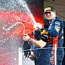 ABU DHABI, UNITED ARAB EMIRATES - NOVEMBER 26: Race winner Max Verstappen of the Netherlands and Oracle Red Bull Racing celebrates on the podium during the F1 Grand Prix of Abu Dhabi at Yas Marina Circuit on November 26, 2023 in Abu Dhabi, United Arab Emirates. (Photo by Mark Thompson/Getty Images)