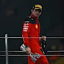 ABU DHABI, UNITED ARAB EMIRATES - NOVEMBER 26: Second placed Charles Leclerc of Monaco and Ferrari celebrates on the podium during the F1 Grand Prix of Abu Dhabi at Yas Marina Circuit on November 26, 2023 in Abu Dhabi, United Arab Emirates. (Photo by Joe Portlock - Formula 1/Formula 1 via Getty Images)