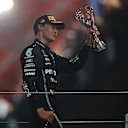 ABU DHABI, UNITED ARAB EMIRATES - NOVEMBER 26: Third placed George Russell of Great Britain and Mercedes celebrates on the podium during the F1 Grand Prix of Abu Dhabi at Yas Marina Circuit on November 26, 2023 in Abu Dhabi, United Arab Emirates. (Photo by Joe Portlock - Formula 1/Formula 1 via Getty Images)