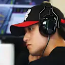 ABU DHABI, UNITED ARAB EMIRATES - NOVEMBER 24: Zhou Guanyu of China and Alfa Romeo F1 looks on in the garage during practice ahead of the F1 Grand Prix of Abu Dhabi at Yas Marina Circuit on November 24, 2023 in Abu Dhabi, United Arab Emirates. (Photo by Dan Istitene - Formula 1/Formula 1 via Getty Images)