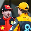 ABU DHABI, UNITED ARAB EMIRATES - NOVEMBER 25: Second placed qualifier Charles Leclerc of Monaco and Ferrari and Third placed qualifier Oscar Piastri of Australia and McLaren talk in parc ferme during qualifying ahead of the F1 Grand Prix of Abu Dhabi at Yas Marina Circuit on November 25, 2023 in Abu Dhabi, United Arab Emirates. (Photo by Mark Thompson/Getty Images)