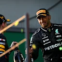 MELBOURNE, AUSTRALIA - APRIL 02: Race winner Max Verstappen of the Netherlands and Oracle Red Bull Racing and  Second placed Lewis Hamilton of Great Britain celebrate on the podium during the F1 Grand Prix of Australia at Albert Park Grand Prix Circuit on April 02, 2023 in Melbourne, Australia. (Photo by Peter Fox/Getty Images)
