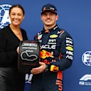 MELBOURNE, AUSTRALIA - APRIL 01: Pole position qualifier Max Verstappen of the Netherlands and Oracle Red Bull Racing is presented with the Pirelli Pole Position trophy by Celeste Barber in parc ferme during qualifying ahead of the F1 Grand Prix of Australia at Albert Park Grand Prix Circuit on April 01, 2023 in Melbourne, Australia. (Photo by Mark Thompson/Getty Images)