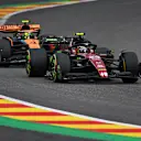 SPA, BELGIUM - JULY 30: Zhou Guanyu of China driving the (24) Alfa Romeo F1 C43 Ferrari leads Lando Norris of Great Britain driving the (4) McLaren MCL60 Mercedes on track during the F1 Grand Prix of Belgium at Circuit de Spa-Francorchamps on July 30, 2023 in Spa, Belgium. (Photo by Dan Mullan/Getty Images)