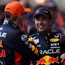 SPA, BELGIUM - JULY 30: Race winner Max Verstappen of the Netherlands and Oracle Red Bull Racing and Second placed Sergio Perez of Mexico and Oracle Red Bull Racing talk in parc ferme during the F1 Grand Prix of Belgium at Circuit de Spa-Francorchamps on July 30, 2023 in Spa, Belgium. (Photo by Dean Mouhtaropoulos - Formula 1/Formula 1 via Getty Images)