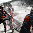 SPA, BELGIUM - JULY 30: Race winner Max Verstappen of the Netherlands and Oracle Red Bull Racing, Second placed Sergio Perez of Mexico and Oracle Red Bull Racing and Greg Reeson, Tyre Technician at Red Bull Racing celebrate on the podium during the F1 Grand Prix of Belgium at Circuit de Spa-Francorchamps on July 30, 2023 in Spa, Belgium. (Photo by Dan Istitene - Formula 1/Formula 1 via Getty Images)