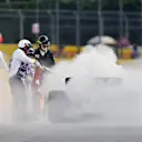 MONTREAL, QUEBEC - JUNE 16: Track marshals use fire extinguishers on the car of Nico Hulkenberg of Germany and Haas F1 during practice ahead of the F1 Grand Prix of Canada at Circuit Gilles Villeneuve on June 16, 2023 in Montreal, Quebec. (Photo by Dan Mullan/Getty Images)