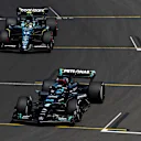 BUDAPEST, HUNGARY - JULY 23: George Russell of Great Britain driving the (63) Mercedes AMG Petronas F1 Team W14 and Fernando Alonso of Spain driving the (14) Aston Martin AMR23 Mercedes make their way to the grid prior to the F1 Grand Prix of Hungary at Hungaroring on July 23, 2023 in Budapest, Hungary. (Photo by Rudy Carezzevoli - Formula 1/Formula 1 via Getty Images)