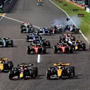 SUZUKA, JAPAN - SEPTEMBER 24: Max Verstappen of the Netherlands driving the (1) Oracle Red Bull Racing RB19 leads Lando Norris of Great Britain driving the (4) McLaren MCL60 Mercedes and Oscar Piastri of Australia driving the (81) McLaren MCL60 Mercedes going into the first corner at the start of the race during the F1 Grand Prix of Japan at Suzuka International Racing Course on September 24, 2023 in Suzuka, Japan. (Photo by Mark Thompson/Getty Images)