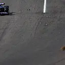SUZUKA, JAPAN - SEPTEMBER 24: Esteban Ocon of France driving the (31) Alpine F1 A523 Renault on track as a marshal sweeps debris from the track during the F1 Grand Prix of Japan at Suzuka International Racing Course on September 24, 2023 in Suzuka, Japan. (Photo by Mark Thompson/Getty Images)