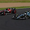 SUZUKA, JAPAN - SEPTEMBER 24: Fernando Alonso of Spain driving the (14) Aston Martin AMR23 Mercedes and Zhou Guanyu of China driving the (24) Alfa Romeo F1 C43 Ferrari compete for position on track during the F1 Grand Prix of Japan at Suzuka International Racing Course on September 24, 2023 in Suzuka, Japan. (Photo by Clive Mason/Getty Images)