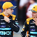 SUZUKA, JAPAN - SEPTEMBER 23:  Second placed qualifier Oscar Piastri of Australia and McLaren talks with Third placed qualifier Lando Norris of Great Britain and McLaren in parc ferme during qualifying ahead of the F1 Grand Prix of Japan at Suzuka International Racing Course on September 23, 2023 in Suzuka, Japan. (Photo by Bryn Lennon - Formula 1/Formula 1 via Getty Images)